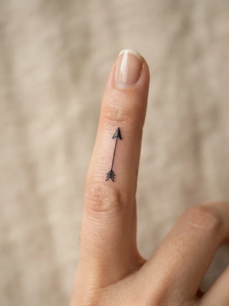 9. Minimalist Arrow Finger Tattoo